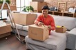 © Krakenimages.com - Young hispanic man smiling confident unpacking cardboard box at new home