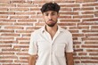 © Krakenimages.com - Arab man with beard standing over bricks wall background depressed and worry for distress, crying angry and afraid. sad expression.