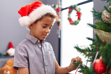 Canvas Print - Adorable hispanic boy smiling confident decorating christmas tree at home