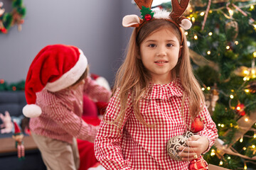 Sticker - Brother and sister holding ball decorating christmas tree at home