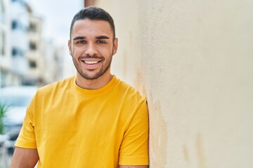 Canvas Print - Young hispanic man smiling confident standing at street