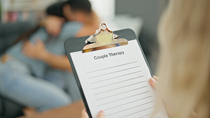 Man and woman sitting on sofa having couple therapy at psychology clinic