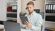 © Krakenimages.com - Young caucasian man business worker using touchpad and laptop at office