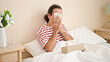 © Krakenimages.com - Middle age man sitting on bed sneezing at bedroom