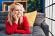 © Krakenimages.com - Young blonde woman smiling confident lying on sofa at home