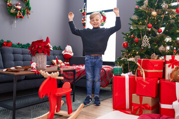 Canvas Print - Adorable toddler smiling confident standing by christmas tree at home