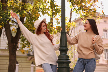 Wall Mural - Happy friends having fun outdoors on autumn day