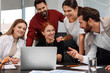 © New Africa - Team of employees working together in office