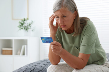 Canvas Print - Upset woman with credit card became fraud victim indoors, space for text