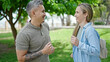 © Krakenimages.com - Man and woman couple smiling confident dancing at park