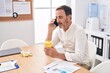 © Krakenimages.com - Middle age man business worker talking on smartphone working at office