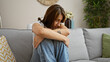 © Krakenimages.com - Young woman stressed sitting on sofa at home