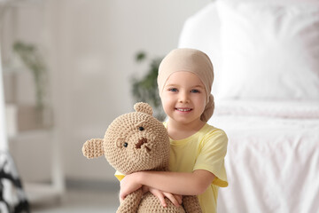 Canvas Print - Little girl after chemotherapy with toy bear in clinic