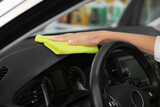 Fototapeta Przestrzenne - Woman cleaning car interior with rag, closeup