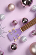 © Pixel-Shot - Composition with ukulele and beautiful Christmas decorations on lilac background