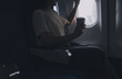 © ARMMY PICCA - Asian woman enjoying enjoys a coffee comfortable flight while sitting in the airplane cabin, Passengers near the window.