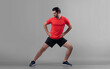 Full body length gaiety shot athletic and sporty young man with fitness warmup and stretching body for pre exercise posture on isolated background. Healthy active and body care lifestyle.