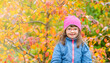 © Ermolaev Alexandr - Portrait of a smiling girl with Downs syndrome at autumn forest. Empty space for text