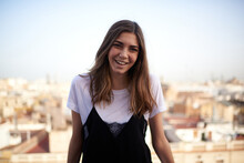 Funny Portrait Of A Young White And Brunette Woman Smiling At The Camera And With Barcelona In The Background