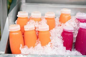 Mixed Ice cold juice bottle in the market, healthy fruit drink concept