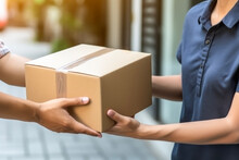 Close Up Hands Of Customer Hand Receiving A Cardboard Box Parcel From Delivery Service Courier. Delivery Concept Of Customer And Worker.