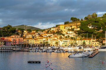 Sticker - view of the harbor marina and Porto Azzurro village on Elba Island at sunset