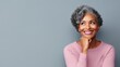 © VIK - portrait of a beautiful middle-aged African American woman with a short gray hairstyle on a plain pastel background