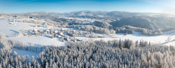 Wall Mural - Aerial view to winter landscape. Snow-covered trees at sunny day. Lomy, Osečnice, Orlicke hory, Eagle Mountains