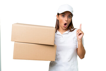 Wall Mural - Delivery caucasian woman holding boxes isolated on green chroma background intending to realizes the solution while lifting a finger up