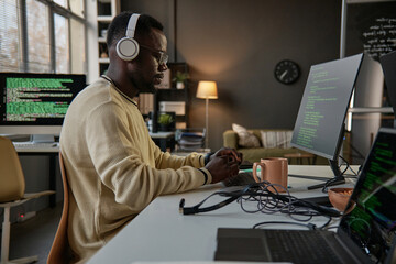 Serious software developer thinking how to fix bug in programming code