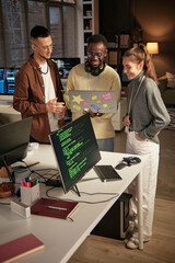 group of happy developers reading first reviews of project they just launched