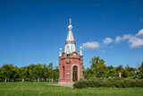 Fototapeta Dmuchawce - A walk around the city on a fine autumn day. The chapel in the park.