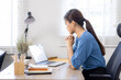 © David - Portrait of young Business asian woman using computer at home sitting in the office working and studying alone. Thoughtful serious woman thinking on new projects.