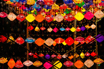 Poster - travel to Georgia - various glowing Chinese lanterns in city park in Batumi at dark night