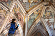 Female Expertise Restorer Retouching Antique Gothic Fresco Under Church Ceiling - Parish Church, Slovenia, Europe