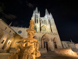 Fototapeta Londyn - View of the medieval metropolitan cathedral of Burgos (Spain), with its French Gothic style facade and towers, illuminated at night.