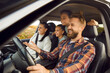 © Studio Romantic - Portrait of happy laughing smiling family of four with children riding in modern car traveling by automobile together enjoying vacation or road trip on weekend. Family travel concept.