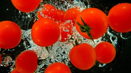 Fototapete - Whole Cherry Tomatoes Dropped in Water.