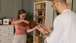 © Stockphotodirectors - Male music teacher giving private violin lessons to a teenage girl