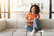 © Prostock-studio - Portrait Of Beautiful Smiling Black Woman Relaxing On Comfortable Couch At Home