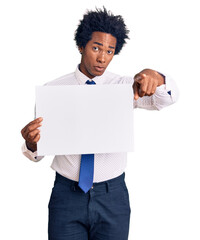 Poster - Handsome african american man with afro hair holding blank empty banner pointing with finger to the camera and to you, confident gesture looking serious