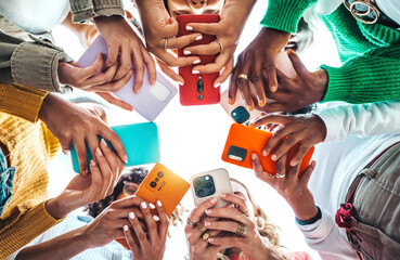 group of young people using smart mobile phone device outside - trendy technology concept with guys 