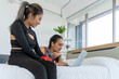 © pixs4u - Two women friends looking at a laptop together