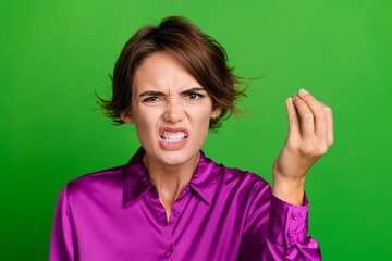 Poster - Photo of crazy outraged furious girl dressed stylish purple clothes showing fingers wtf problem trouble isolated on green color background