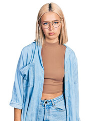 Sticker - Beautiful young blonde woman wearing glasses depressed and worry for distress, crying angry and afraid. sad expression.