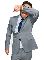 Wall Mural - Middle age man wearing business clothes covering eyes with arm smiling cheerful and funny. blind concept.