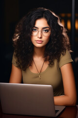 Poster - Woman with glasses is looking at laptop screen.