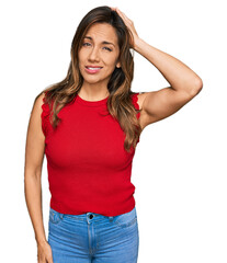 Poster - Young hispanic woman wearing casual clothes confuse and wonder about question. uncertain with doubt, thinking with hand on head. pensive concept.