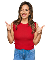 Wall Mural - Young hispanic woman wearing casual clothes success sign doing positive gesture with hand, thumbs up smiling and happy. cheerful expression and winner gesture.