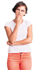 Poster - Beautiful young woman with short hair wearing casual clothes serious face thinking about question with hand on chin, thoughtful about confusing idea